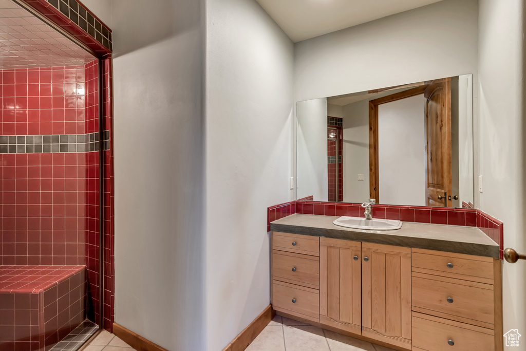 Bathroom featuring large vanity and tile flooring
