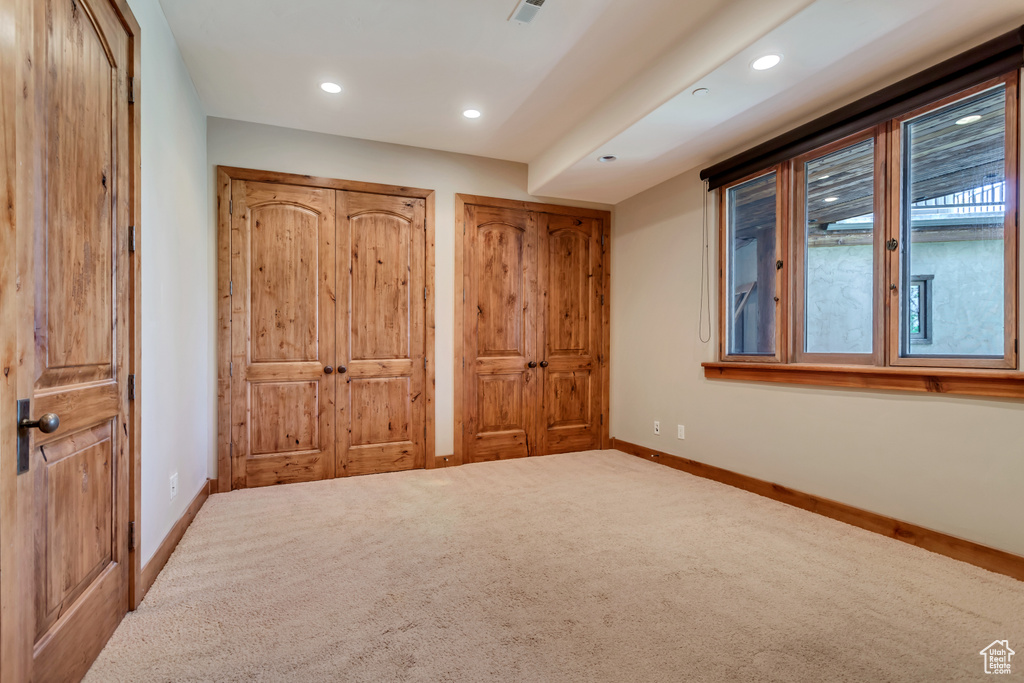 Unfurnished bedroom with carpet flooring