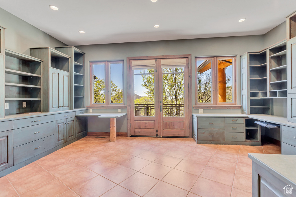 Unfurnished office featuring light tile flooring