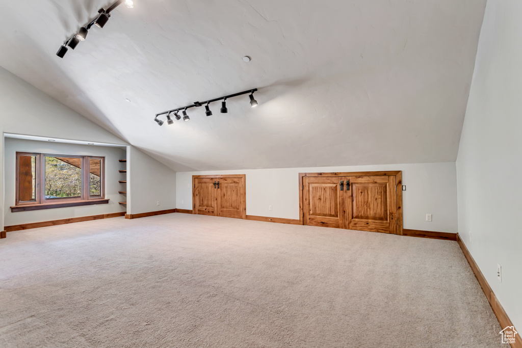 Bonus room featuring carpet flooring and vaulted ceiling