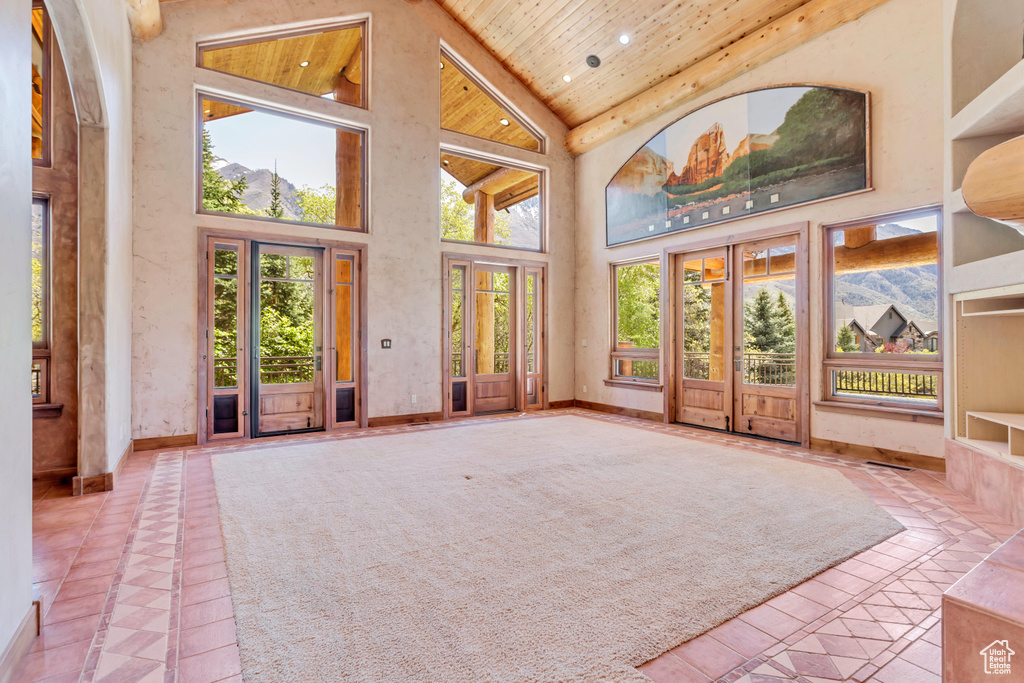 Unfurnished sunroom with vaulted ceiling, french doors, and wood ceiling
