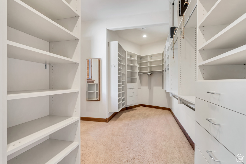 Walk in closet with light carpet