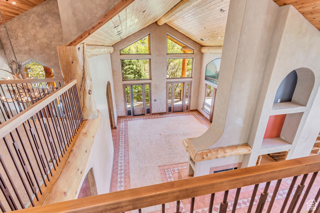 Living room with high vaulted ceiling, beam ceiling, a chandelier, and wood ceiling