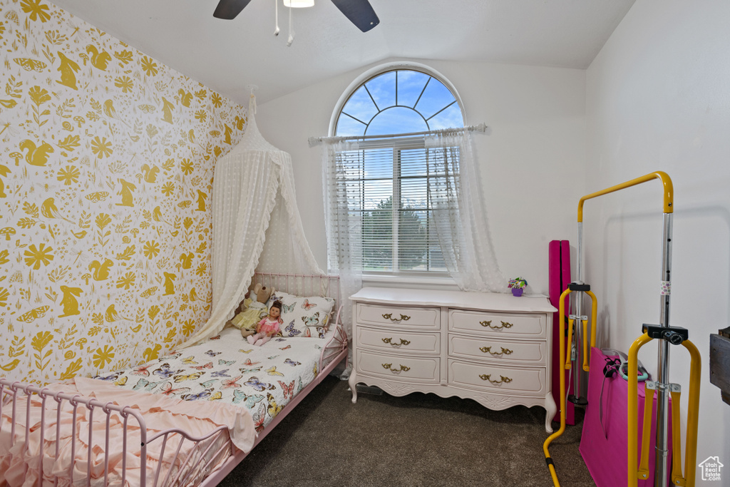 Bedroom featuring vaulted ceiling, ceiling fan, and carpet