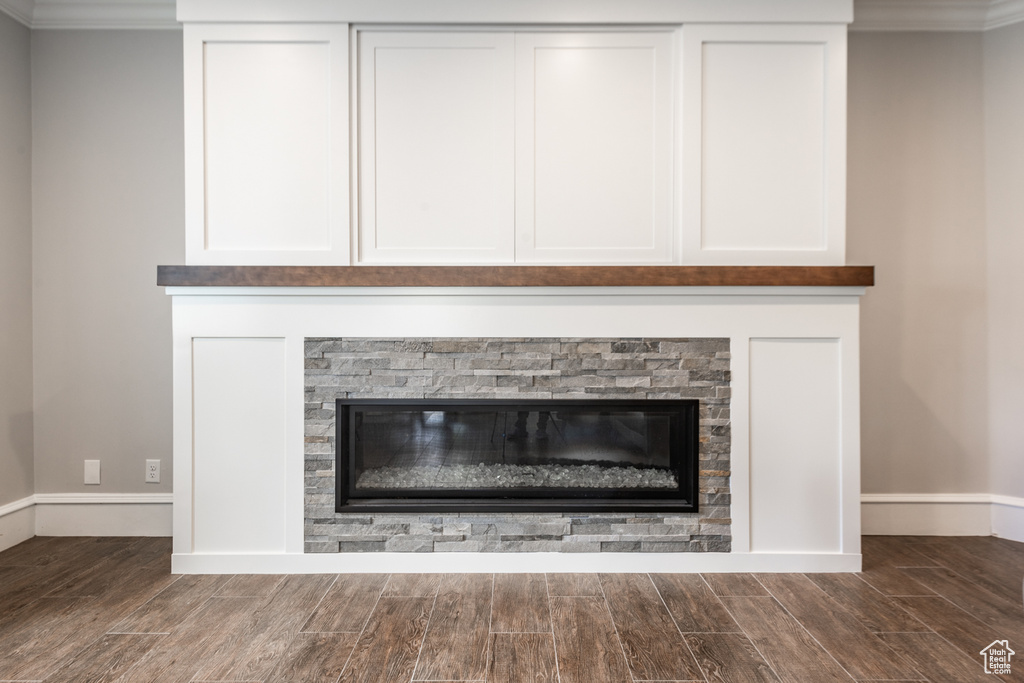 Details with a fireplace, dark hardwood / wood-style flooring, and crown molding