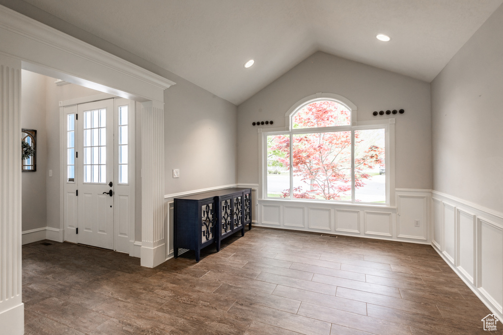 Foyer with hardwood / wood-style floors and lofted ceiling