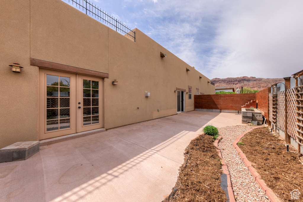 Exterior space featuring french doors, a mountain view, and a patio