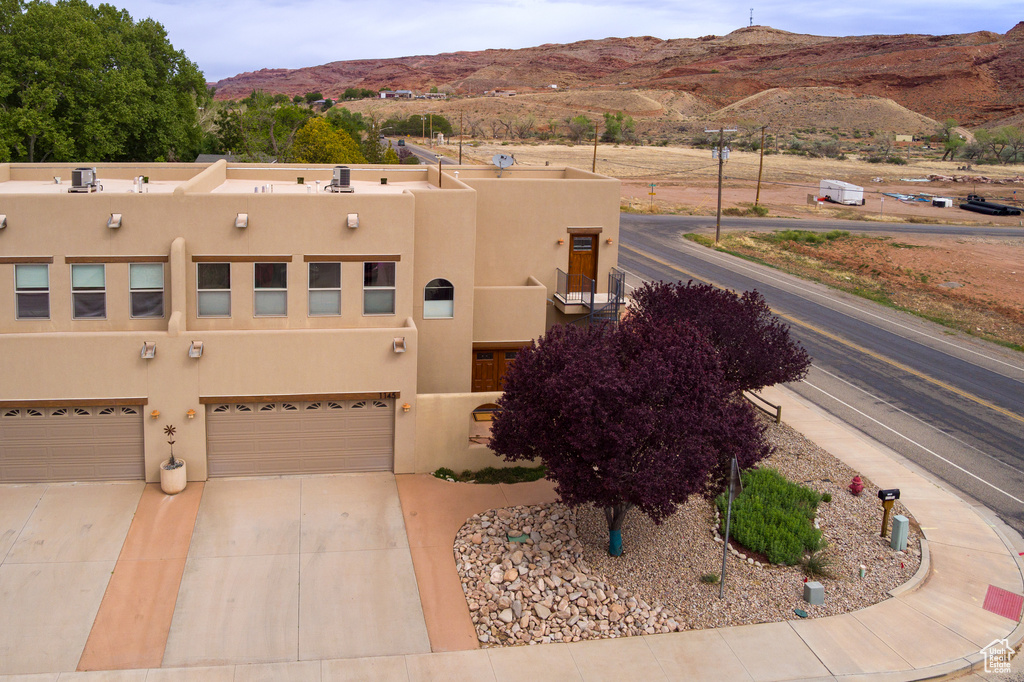 View of front facade featuring a mountain view and a garage