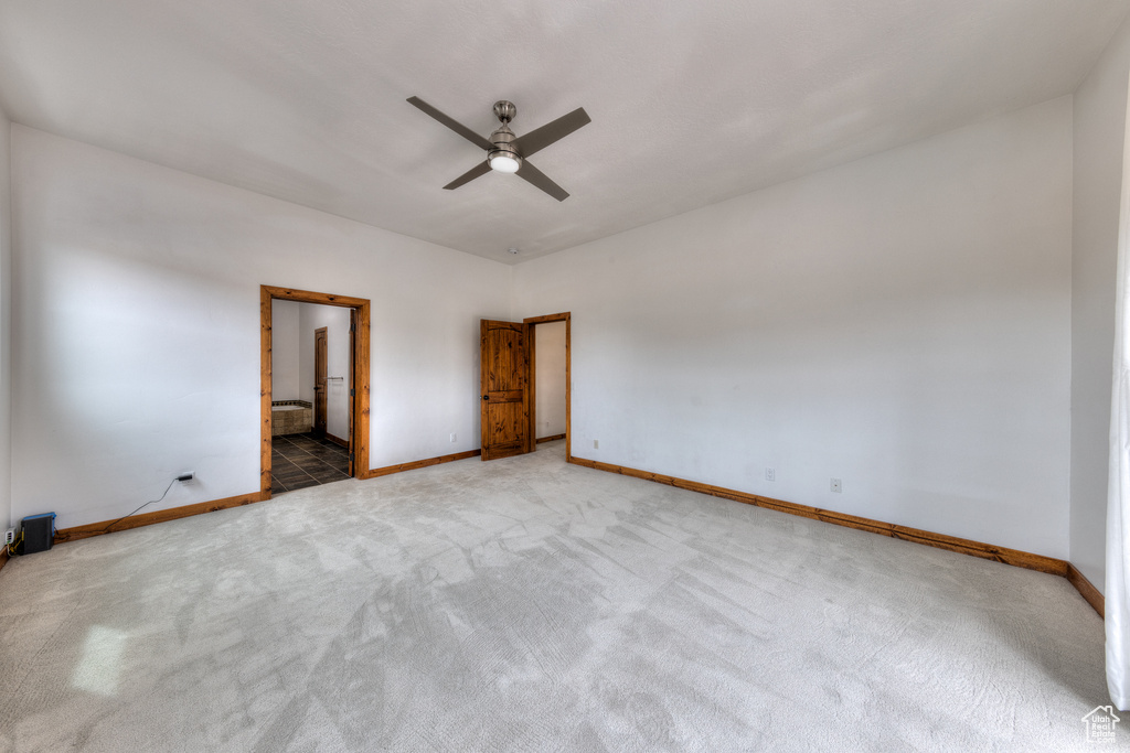 Unfurnished room with ceiling fan and carpet flooring