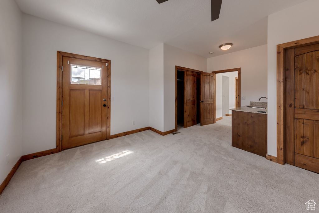 Entryway with sink and light carpet