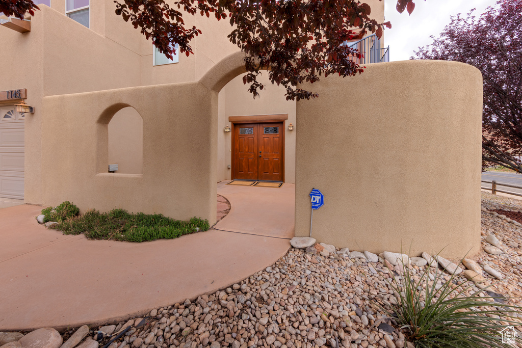 Doorway to property featuring a garage