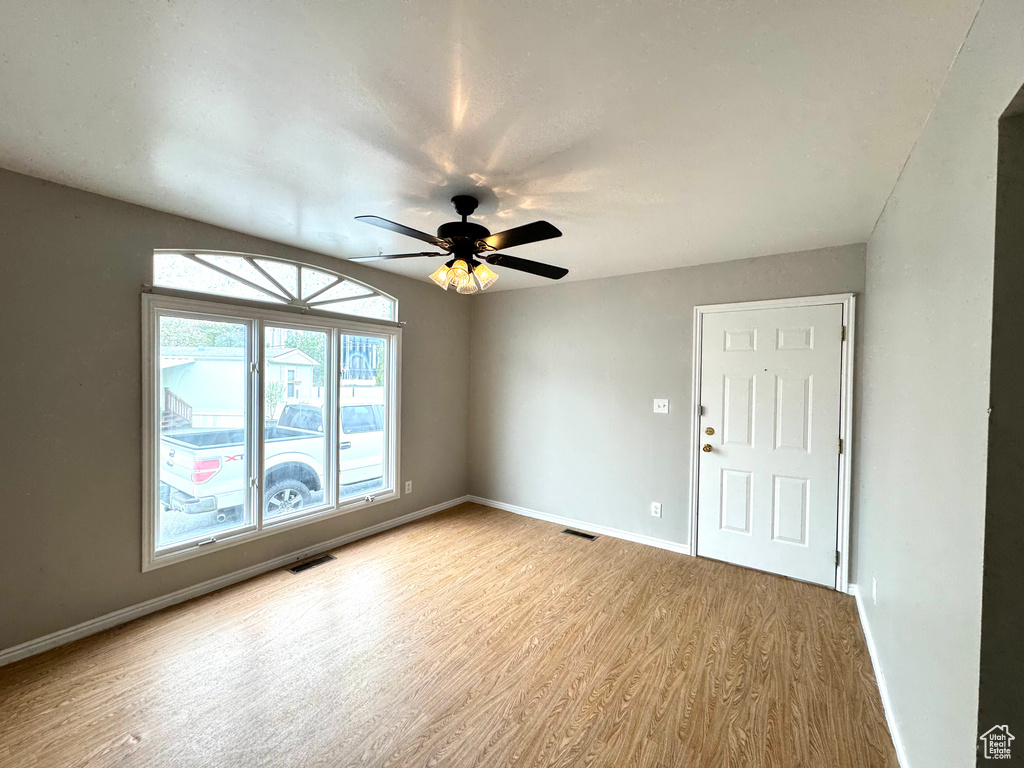 Empty room featuring ceiling fan and light hardwood / wood-style floors