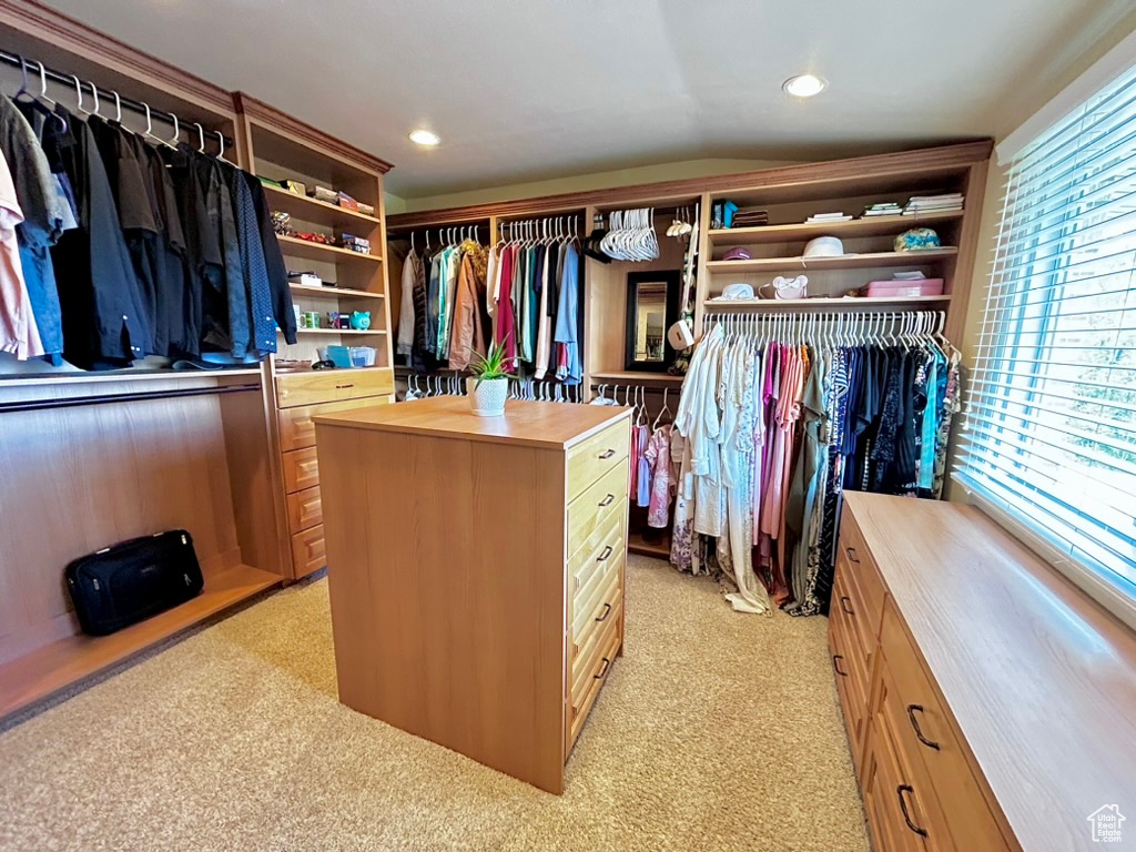 Walk in closet with light colored carpet