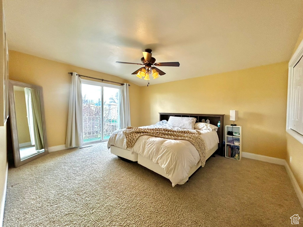 Bedroom with ceiling fan, access to exterior, and carpet floors