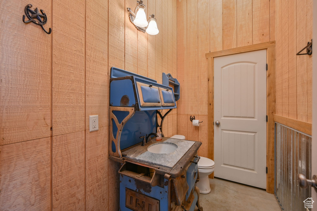 Miscellaneous room with wood walls and sink