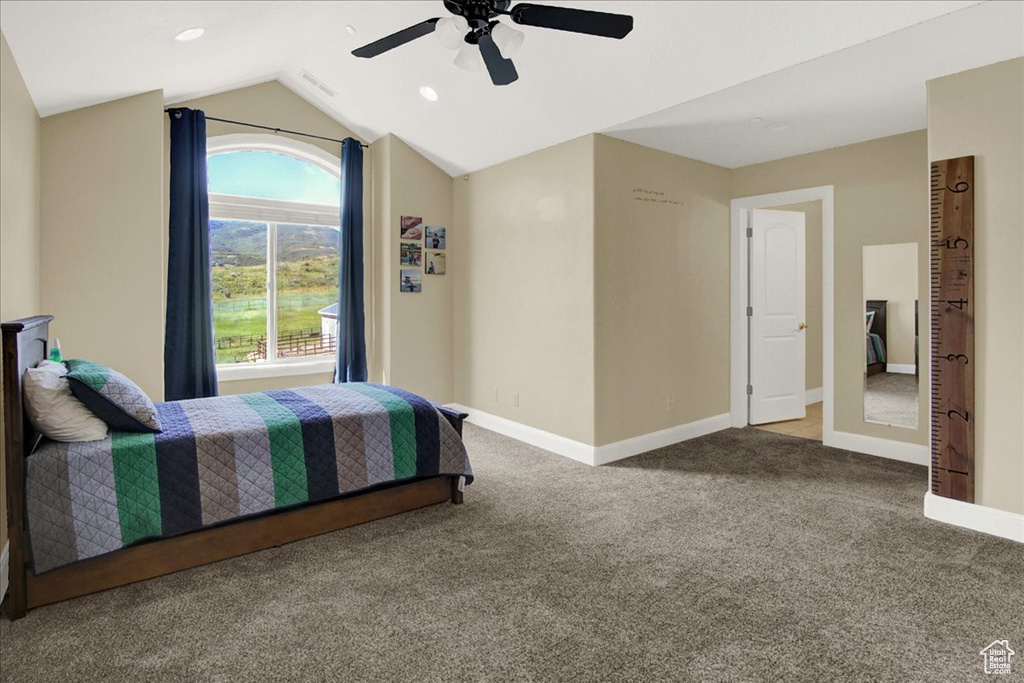 Bedroom featuring carpet flooring, ceiling fan, and lofted ceiling
