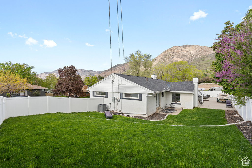 View of yard featuring central AC, a mountain view, and a patio