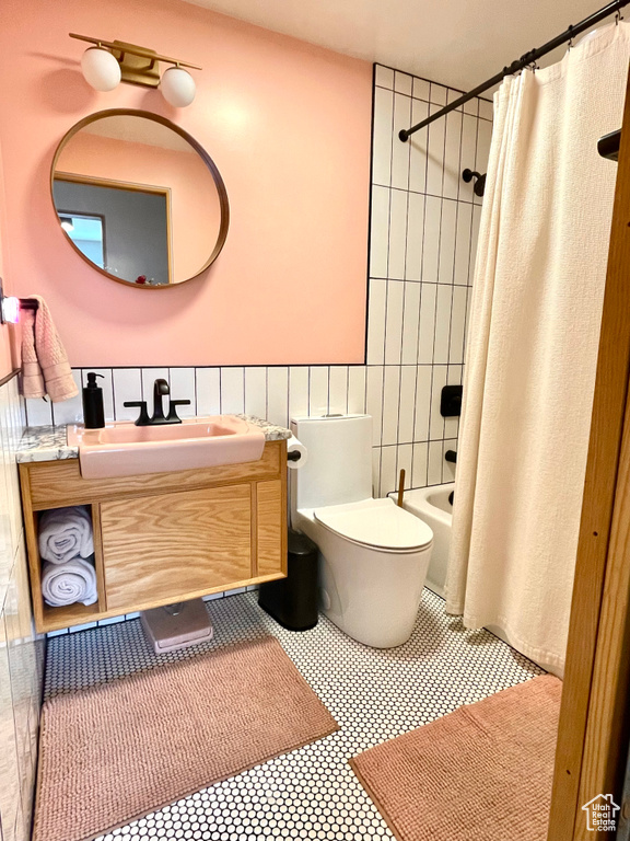 Full bathroom with vanity, toilet, and shower / bathtub combination with curtain