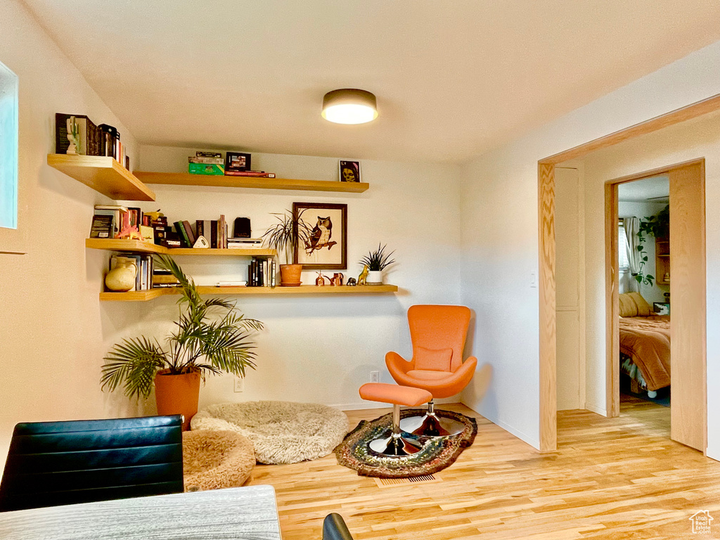 Sitting room with hardwood / wood-style floors