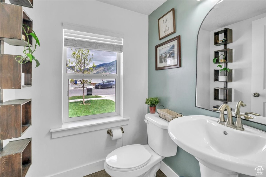 Bathroom with a healthy amount of sunlight, sink, a mountain view, and toilet