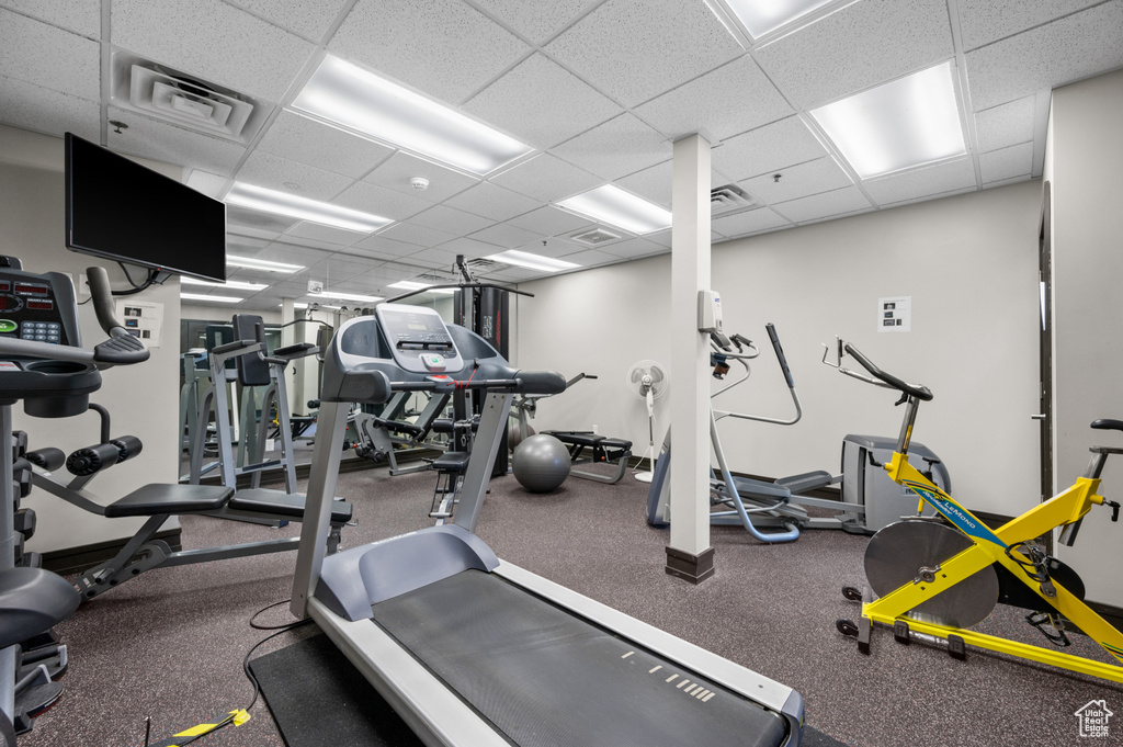 Exercise room with a drop ceiling and carpet