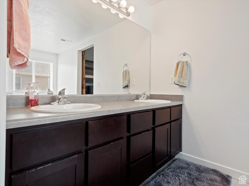 Bathroom with oversized vanity and dual sinks