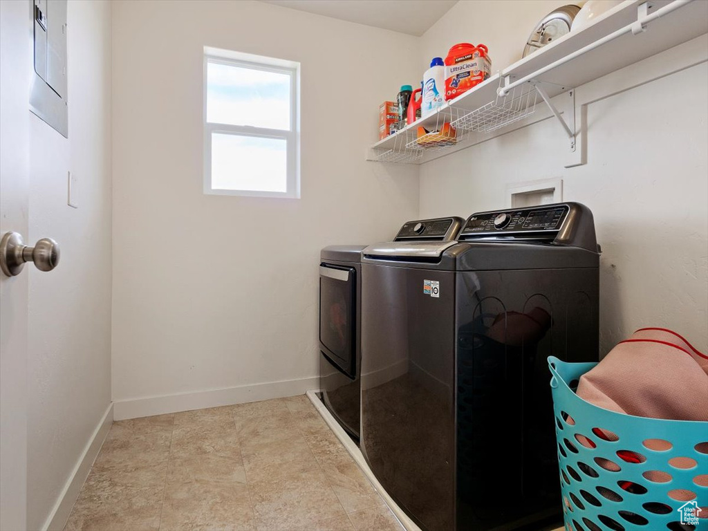 Laundry area with washer hookup, tile flooring, and separate washer and dryer