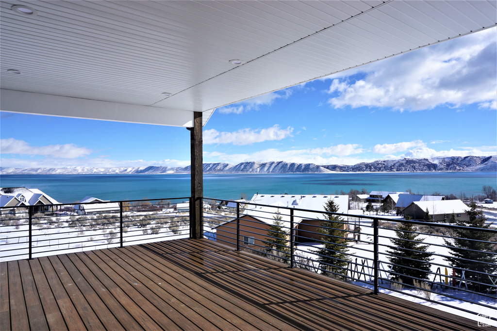 Wooden deck with a water and mountain view