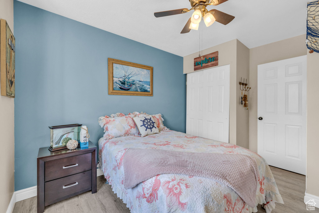 Bedroom featuring a closet, ceiling fan, and light wood-type flooring