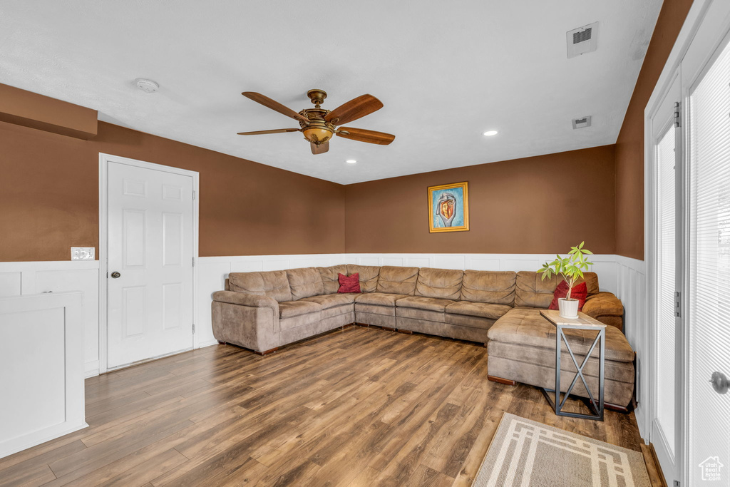 Living room featuring hardwood / wood-style flooring and ceiling fan