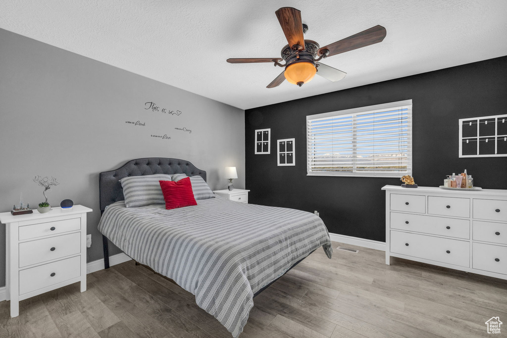 Bedroom featuring ceiling fan and light wood-type flooring