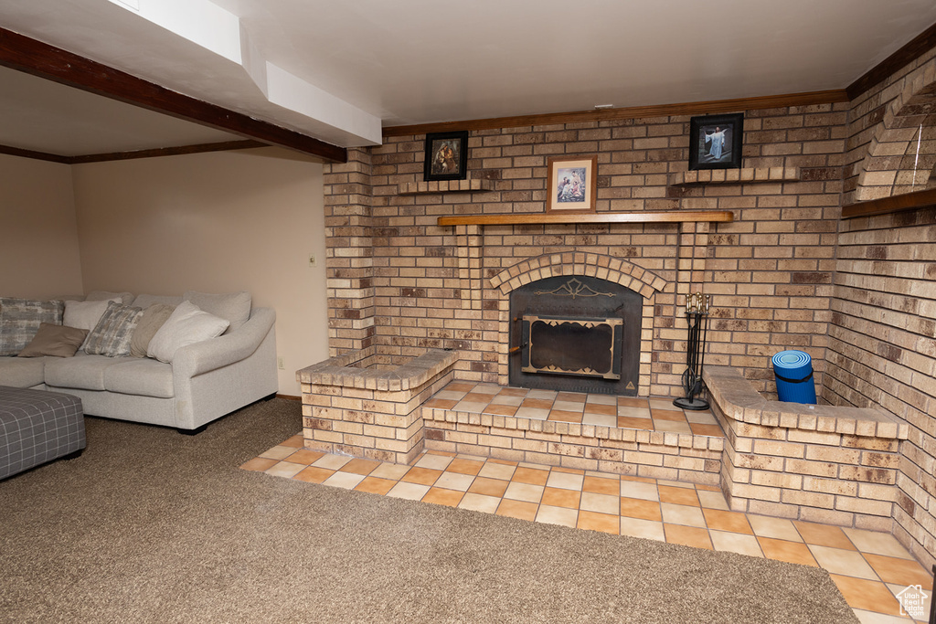 Tiled living room featuring beam ceiling and a brick fireplace