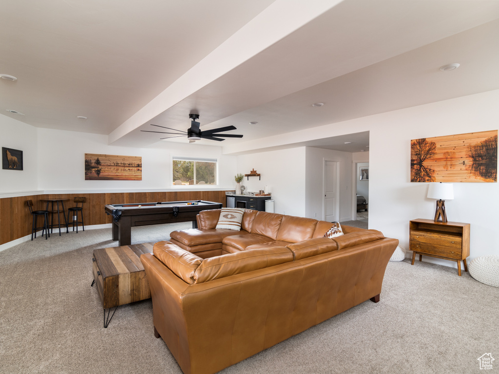 Carpeted living room featuring beamed ceiling, pool table, and ceiling fan
