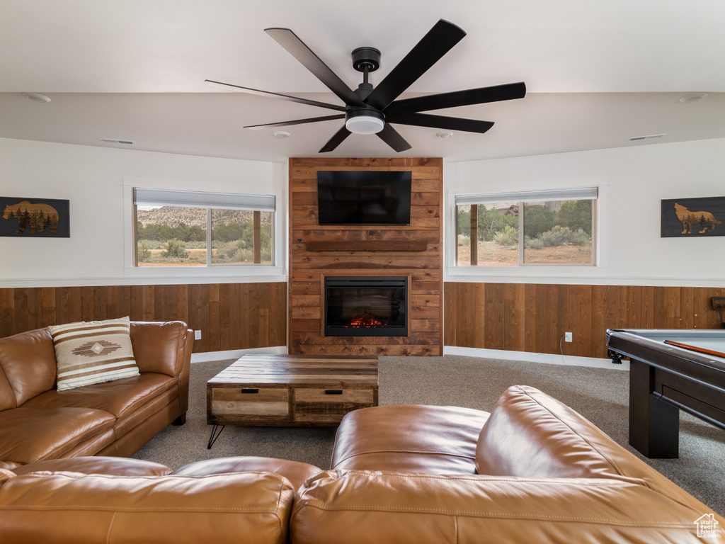 Carpeted living room with plenty of natural light, pool table, ceiling fan, and a fireplace