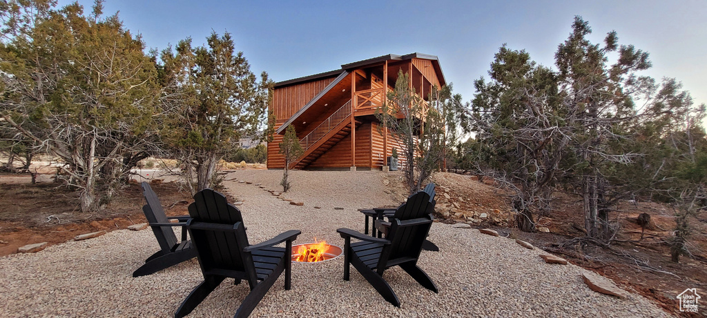 Exterior space with an outdoor fire pit and a wooden deck