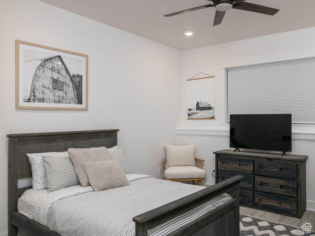 Bedroom with light hardwood / wood-style flooring and ceiling fan