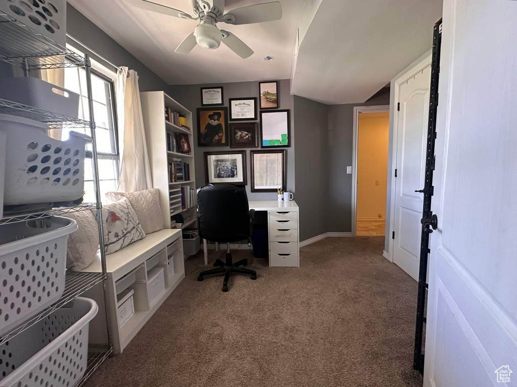 Carpeted office with a healthy amount of sunlight and ceiling fan