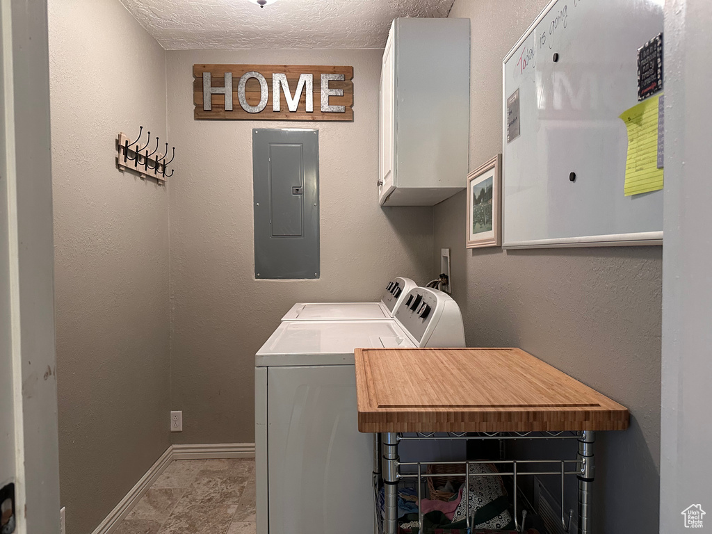 Laundry room with washer and clothes dryer, tile floors, washer hookup, cabinets, and a textured ceiling