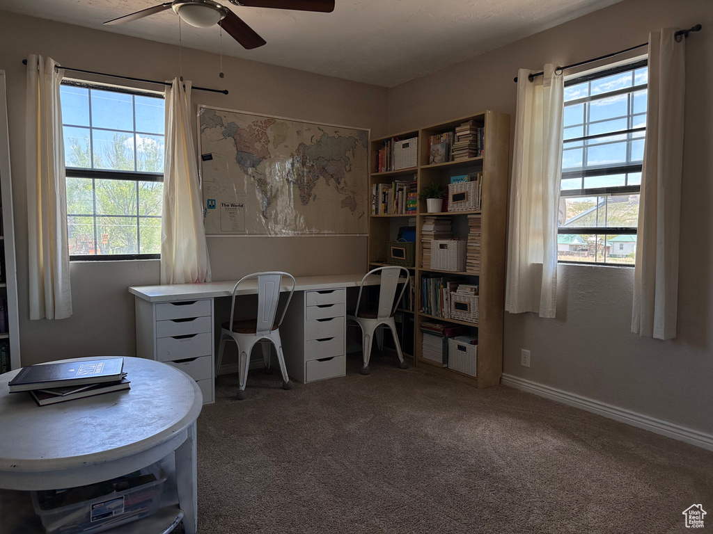 Home office featuring ceiling fan and carpet flooring