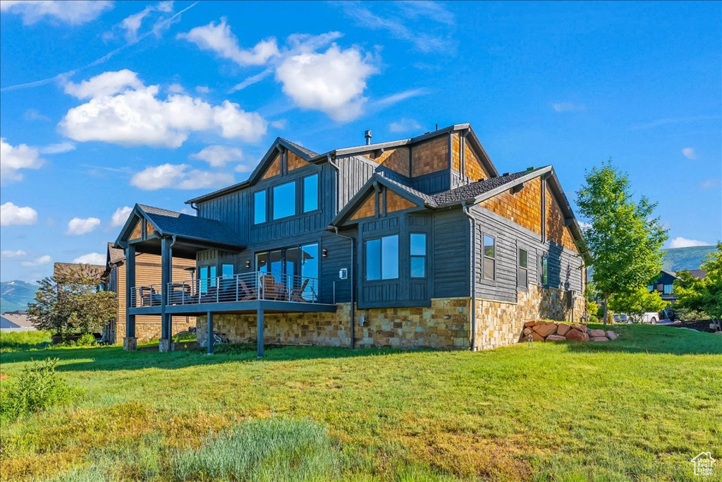 Rear view of house featuring a lawn