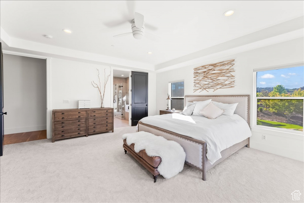 Carpeted bedroom featuring ceiling fan