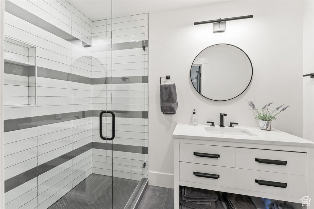 Bathroom featuring an enclosed shower and vanity