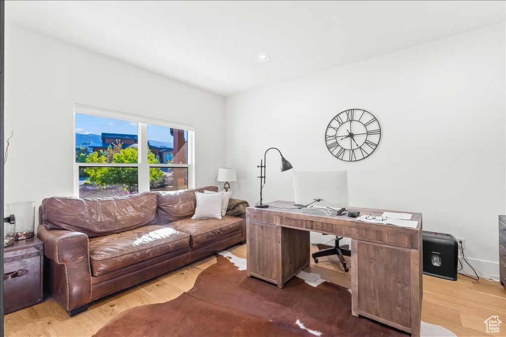 Office space with hardwood / wood-style floors