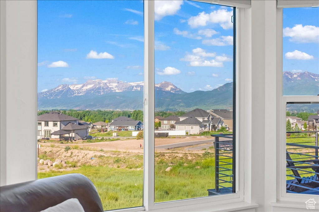 Doorway to outside with a mountain view and a wealth of natural light