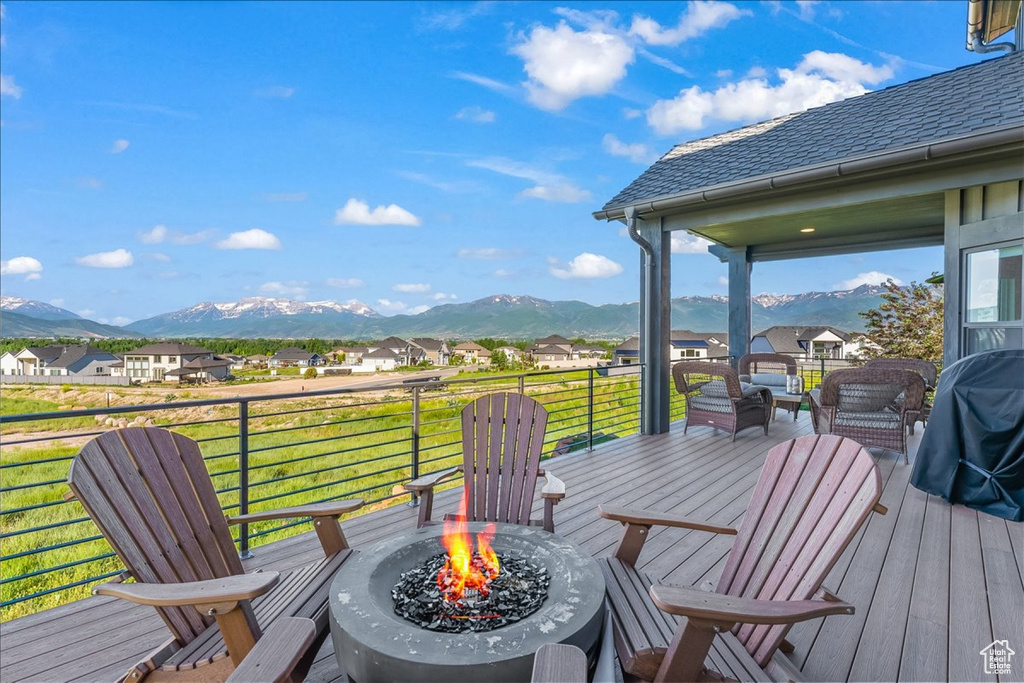 Wooden terrace with a mountain view and a yard