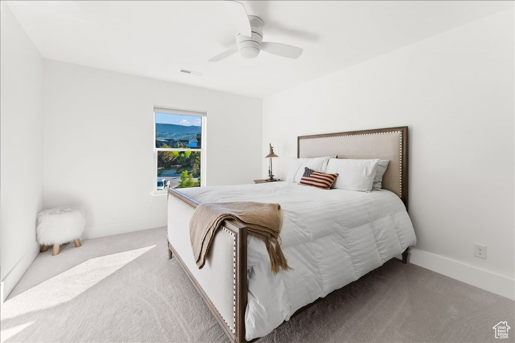 Carpeted bedroom with ceiling fan