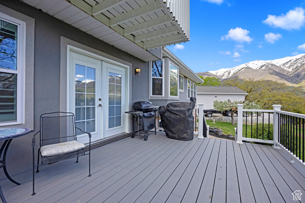 Wooden deck with grilling area and a mountain view
