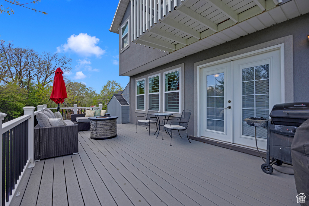 Wooden deck featuring french doors and outdoor lounge area