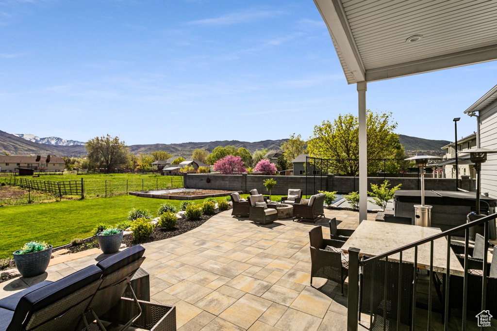 View of patio with an outdoor living space and a mountain view
