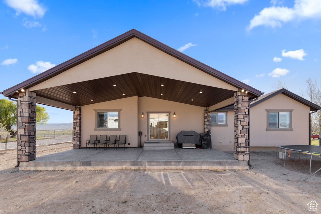 Exterior space with a patio area and a trampoline